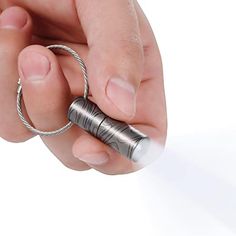 a person is holding a small silver object in their hand