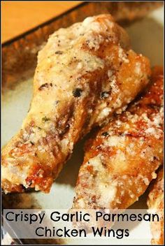 crispy garlic parmesan chicken wings on a white plate with the words crispy garlic parmesan chicken wings