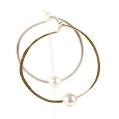 These timeless pearl hoops are made by hand and have a slight irregularity to keep them interesting. Wear this classic shape daily or for a night out on the town. These make a great gift, easily worn for years by earring wearers of all ages and tastes. A variation of our Classic Hoops with a pearl. Product Details: -Available in solid sterling silver or 14k gold fill -Hammered 1.25in hoop with a hook clasp sold as a pair. -Pearl is an AAA-grade freshwater pearl that measures 5-6mm. All items are Akoya Pearls, Hook Clasp, Freshwater Pearls, Gold Filled, Great Gifts, Bangles, Hoop Earrings, Sterling Silver, Silver