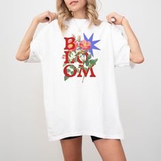 Vintage Bloom Retro Floral Shirt for Boho Beauties & Flower Enthusiasts  👚THE UNISEX COMFORT COLORS C1717 SHORT SLEEVE TEE👚 🔹Features: * Unisex sizing * Made from 100% ring-spun cotton * Comfortable, relaxed fit * Twill label sewn inside * Medium weight fabric (6.1 oz/yd² or 206.8 g/m²) Want the popular oversized dress look by ordering two sizes up from your regular size. 📏Check the sizing chart in the product photos for more details. 📋👕Easy measuring tip: Simply take your favorite shirt, lay it flat, and measure from armpit to armpit for the width, and from top to bottom for the length. Compare these measurements to those of your preferred shirt. ⏳🚚Production and Shipping -Orders are processed within 1-3 days to print and ship. Estimated shipping times are given but in almost all c Relaxed Fit Cotton Blouse With Graphic Print, Cotton Graphic Print Blouse With Relaxed Fit, Cotton Blouse With Graphic Print And Relaxed Fit, White Cotton Blouse With Graphic Print, Red Floral Print Cotton T-shirt, Boho Beauty, Oversized Dress, Inspirational Shirt, Flower Beauty