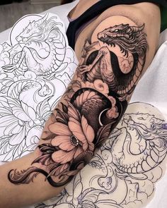 a woman's arm covered in tattoos with flowers and an octopus on the side