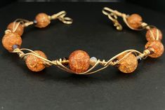 Embrace the warmth of a breathtaking sunset wherever you go with our exquisite gold wire wrapped bracelet adorned with dyed crackled orange quartz beads and delicate glass accents. The Radiant Sunset Dreams Bracelet is not just jewelry; it's a wearable masterpiece that captures the essence of nature's most mesmerizing moments. 🔥 Handcrafted Elegance: Each bracelet is meticulously handcrafted by skilled artisans, ensuring a unique and individual touch. The gold wire wrapping adds a touch of sophistication, creating a harmonious blend of modern chic and timeless elegance. 🧡 Captivating Orange Quartz: The dyed crackled orange quartz beads are the heart of this piece, radiating a warm and vibrant energy. These beads are not just beautiful; they're believed to carry positive and healing prope Orange Quartz, Dream Bracelet, Wire Wrapped Bracelet, Vibrant Energy, Wire Rings, Quartz Beads, Gold Wire, Modern Chic, Meaningful Gifts