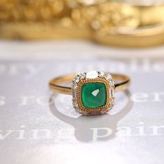 *Condition: Brand new *Center Stone: Natura Emerald from Zambia, approx 0.68ct, 6x6mm (IF clarity, 5A color) *Side Stone: Natural White Diamond, Round Cut & Baguette Cut (VS1 clarity and F color) *Gold Weight: 3.41g (depand the ring size) *Ring Dimension: approx 10x10x8.5mm *Metal Purity: Can be select Each piece is made-to-order with care and special attention to detail. all items are made with conflict-free diamonds and gems. Size: made to order The item will be gift wrapped and shipped. - Elegant Moissanite Emerald Ring For Proposal, Fine Jewelry Proposal Ring With Baguette Cut, Elegant Yellow Gold Emerald Ring For Proposal, Fine Jewelry Baguette Cut Ring For Proposal, Formal Emerald Halo Ring Fine Jewelry, Luxury Emerald Rings With Halo Detail, Formal 14k Gold Emerald Ring With Halo, 14k Gold Emerald Cut Halo Setting Ring, Yellow Gold Emerald Diamond Ring With Halo Design