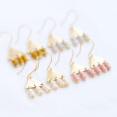 A lovely pair of little Triangle Brass Earrings.The little earrings measure.5" long and are made with golden brass triangles and three tiny-beaded bars hanging down.DETAILSDrop: 0.5" longMetal: Golden BrassEarwires: 24K Gold Plated Three rows of hanging 3mm Czech glass beadsChoose:MustardLight GreyCreamPinkHandmade in our Burlington VT studioShipped in a gift box Adjustable Hypoallergenic Gold Linear Earrings, Handmade Geometric Gold Earrings, Tiny Modern Gold Earrings, Handmade Gold Linear Earrings For Everyday, Dainty Gold Linear Earrings, Gold Dainty Linear Earrings, Tiny Minimalist Dangle Earrings, Gold Geometric Earrings For Everyday, Gold Dainty Linear Metal Earrings