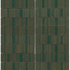 a green tile wall with vertical lines in the center and diagonals on each side