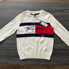 Brand New Tommy Hilfiger Sweater. White In Color. White Tommy Hilfiger Cotton Sweater, Tommy Hilfiger White Long Sleeve Tops, Tommy Hilfiger White Casual Sweater, Casual White Tommy Hilfiger Sweater, School Sweater, Tommy Hilfiger Long Sleeve, Tommy Hilfiger Girl, Tommy Hilfiger Sweater, Quarter Zip Sweater