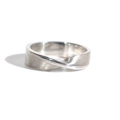 Who doesn't love a simple mobius strip, its a great simple change from a plain band.  The one pictured here is made of solid recycled sterling silver, the first three images show a 5mm wide by 1.5mm thick mobius ring.  I can make this ring in other widths.  Please see the fourth image to get an idea of how the ring design translates.  8mm and 10 mm wide will be 2mm thick instead of 1.5mm.I love the look of a brushed mobius ring with a polished edge but I am more than happy to do an all polished Mobius Rings, Modern Twist Silver Rings With Polished Finish, Mobius Strip Ring, Sterling Silver Jewelry With Ring Detail, Modern Twist, Mobius Strip, Mobius Ring, Hinged Ring, Metalsmithing Jewelry, Plain Bands