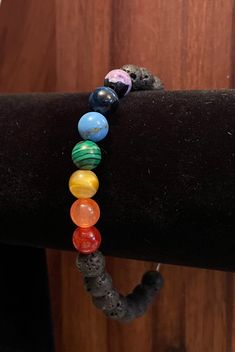 Chakra lava bead using semi precious stones. Wear your favorite essential oils all day! 🟣 purple ice flower agate 🔵 blue tigers eye 💙 blue shell turquoise  🟢 malachite  🟡 yellow tigers eye  🟠 orange chalcedony  🔴 fire agate Healing Lava Stone Bracelets With Gemstone Beads, Healing Bracelet With Gemstone Beads And Lava Stone, Healing Lava Stone Beaded Bracelets With Round Beads, Doctor Earrings, Palmer Ak, Yellow Tigers Eye, Ice Flower, Lava Bead Bracelet, Blue Shell