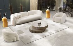 a living room filled with white couches and yellow tables next to each other on top of tiled flooring