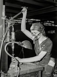 a woman working on a machine in a factory