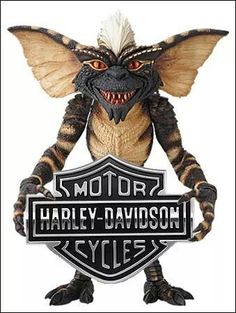 a close up of a motorcycle sign with a demon on it's face and the words harley davidson cycles