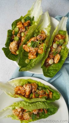 lettuce wraps with chicken and sesame seeds on them, ready to be eaten