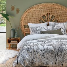 a bed with an intricate headboard and pillows