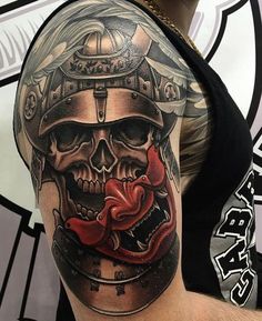 a man with a tattoo on his arm wearing a helmet and skull headdress