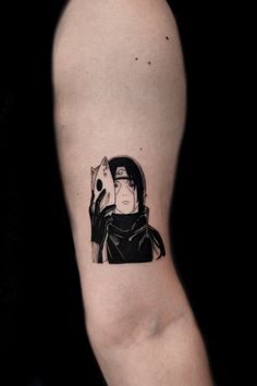 a person with a black and white tattoo on their arm holding a skull in one hand