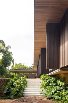 the stairs lead up to the upper level of this modern house with wood paneling