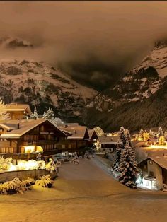 the snow covered mountains are lit up with lights