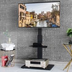 a flat screen tv sitting on top of a wooden stand next to a brick wall