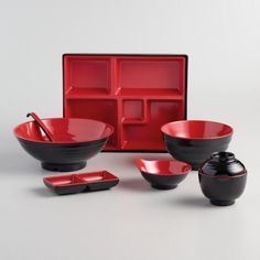 an assortment of red and black dishes