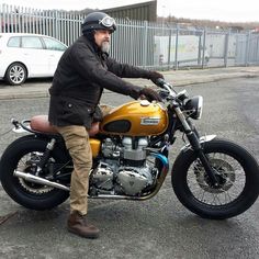 a man sitting on top of a yellow motorcycle