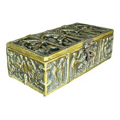 an ornately decorated metal box on a white background