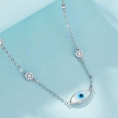 Channel effortless boho chic with this sterling silver evil eye choker necklace. Crafted from high-quality 925 sterling silver, this protective amulet features an evil eye charm embellished with sparkling cubic zirconia stones star beads on both sides that catch the light. Whether you're after a touch of Turkish style or want to ward off negative energy, this choker necklace is a stylish way to embrace the power of the evil eye. Slip it on to channel good vibes and make a statement with effortle Sterling Silver Evil Eye Necklaces, Silver Sterling Silver Evil Eye Bracelet, Dainty Style, Silver Sterling Silver Evil Eye Bracelet Dainty Style, Dainty Silver Sterling Evil Eye Bracelet, Elegant Silver Evil Eye Charm Necklace, Dainty Silver Necklace With Evil Eye, Sterling Silver Choker Necklace, Sterling Silver Choker, Silver Choker Necklace