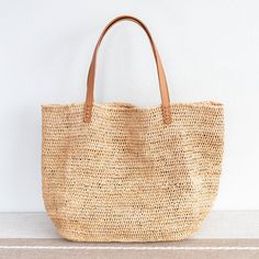 Chic large straw woven tote bag perfect for all occasions. This tote bag is sure to keep up with your busy lifestyle, providing a lightweight and durable design with a classic aesthetic. It’s the perfect way to stay organized while making a stylish statement. Natural Soft Raffia Straw Genuine leather handlesNo linerDimensions: 14"H x 20"W x 8.5"D10" handle drop Designer Style ID: 8583 Large Straw Woven Tote Bag, Summer Bag, Everyday Shoulder Bag, Beach Bag Everyday Handwoven Tote Bucket Bag, Handwoven Beach Bag For Everyday Use With Double Handle, Everyday Handwoven Beach Bag With Double Handle, Eco-friendly Shoulder Bag With Braided Handles For Everyday, Natural Bucket Bag With Braided Handles For Daily Use, Brown Straw Bags With Rolled Handles, Everyday Use Handwoven Beach Bag With Double Handle, Everyday Natural Fiber Bucket Bag With Braided Handles, Handwoven Tote Straw Bag For Everyday Use