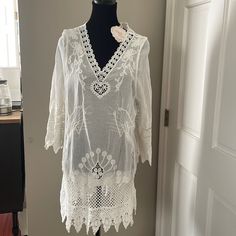 This White Embroidered Dress Would Be Perfect For A Beach Cover Up Or Summer Dress. The Detailing Of The Fabric Is Very Elegant. Elegant Embroidered Fitted Tunic, Elegant White Spring Tunic, Elegant Embroidered V-neck Beach Dress, Elegant V-neck Embroidered Dress For Beach, Fitted V-neck Embroidered Beach Dress, White Lace Trim Tunic Dress, Elegant White Tunic With Floral Embroidery, Elegant White Tunic For Summer, Elegant White Summer Tunic