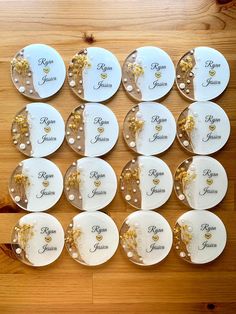 there are many plates on the table with names and gold decorations around them, all arranged in rows