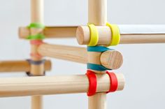 a close up of a wooden toy with colored bands on it's handles and sides