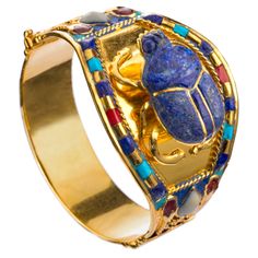 Scarab 24k Golden Plated Bracelet From Ancient Egyptian King Tutankhamun Collection Adornments Held Great Importance In Ancient Egyptian Society, With Jewelry Being An Integral Part Of Their Culture And Traditions. The Scarab Beetle Was A Common Piece Of Jewelry In Ancient Egypt, With The Color Blue Symbolizing The Sunrise And Renewal. These Archaeological Pieces Reflect The Richness Of Ancient Egyptian Culture And The Depth Of Their Spiritual And Artistic Thinking. The Original Pieces Were Made Egyptian Jewelry Ancient Treasures, Ancient Egyptian Jewelry Ancient Treasures, Egyptian Jewelry Ancient Aura Jewelry, Ceremonial Gold Bracelets With Gemstones, Gringotts Vault, King Tutankhamun, Egyptian Bracelet, Egyptian King, Ancient Egyptian Jewelry