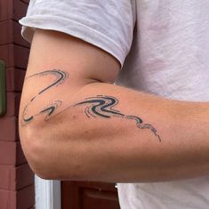 a man with a tattoo on his arm