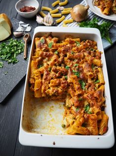 a casserole dish with meat and cheese on the side, ready to be eaten