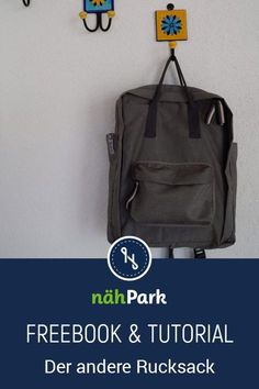 a backpack hanging on the wall with hooks and magnets attached to it's side