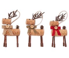 three reindeer ornaments made out of wine corks and burlocks with bows on them