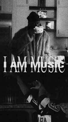 i am music poster with a man in a fur coat sitting on a kitchen counter