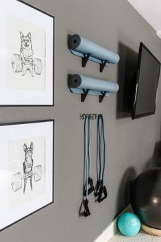 there is a wall mounted tv and some exercise equipment on the wall next to it