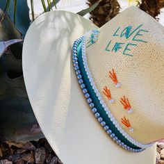 Palm Springs aka "Love Life" embroidered with colorful beads, & faux white pearl fashionable band embody this Mexican Artisan design at its finest! This Hand made/hand painted fedora hat features bright "Palm Springs" colors with its signature Pearls & hand embroidered LOVE LIFE. Also, features an elastic band for a very comfortable feel! DETAILS Sombrero Box Inner-elastic band (comfortable sizing) Tooled Leather Handbags, Hat Art, Artisan Fashion, Painted Hats, Handmade Hair Clip, Diy Jewlery, Bohemian Summer, Hat Patches, Embroidered Leather