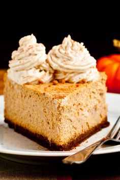 a piece of pumpkin cheesecake on a plate with a fork and knife next to it