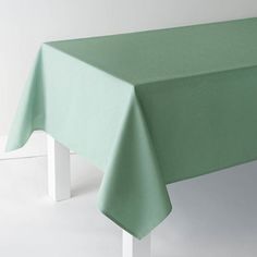 a green table cloth on top of a white chair