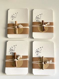 four cards with brown and white paper tied to each other, one has a cross on it