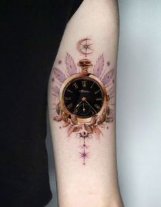 a person with a tattoo on their arm has a pocket watch and stars around it