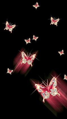 a group of butterflies flying through the air with bright lights on their wings and back