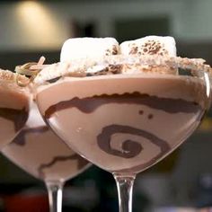 two glasses filled with chocolate and marshmallows