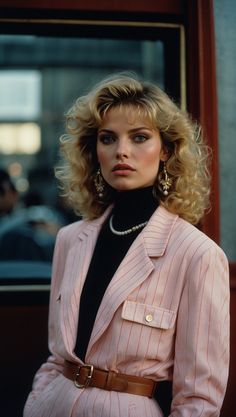 Woman wearing 80s fashion with a pink pinstripe blazer, black turtleneck, and pearl accessories 80s Power Dressing, 80s Power Suit For Women, 80s Clothes 1980s Fashion Trends, 80s Fashion Inspiration, 80s Business Woman, Extravagant Accessories, Ways To Change Your Look, Extravagant Outfits