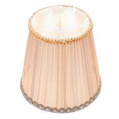 a beige lamp shade with silver trim