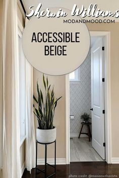 there is a white sign that says accessible beige in front of a door with a potted plant next to it