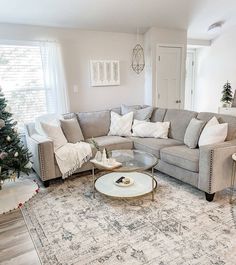 a living room filled with furniture and a christmas tree