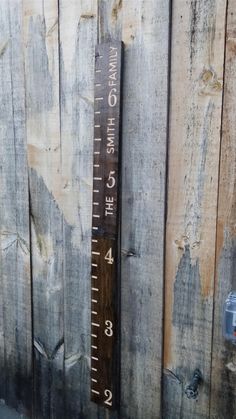 a wooden sign on the side of a fence that says it's 4 o'clock