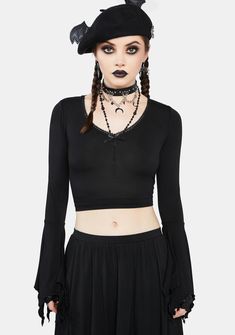 cuz you're the coolest one in the colony. This cropped top has bat wing graphics printed at back, long sleeves with handkerchief cuffs, a lace-trimmed neckline, and a bow applique at the bust. Punk Style Long Sleeve Stretch Crop Top, Gothic Long Sleeve Tops For Spring, Gothic Tops With Lace Trim For Fall, Long Sleeve Crop Top With Lace Trim For Party, Long Sleeve Lace Trim Crop Top For Party, Gothic Stretch Tops With Lace Trim, Gothic Tops With Lace Trim And Stretch, Long Sleeve Cotton Crop Top For Night Out, Witchy Long Sleeve Tops For Party